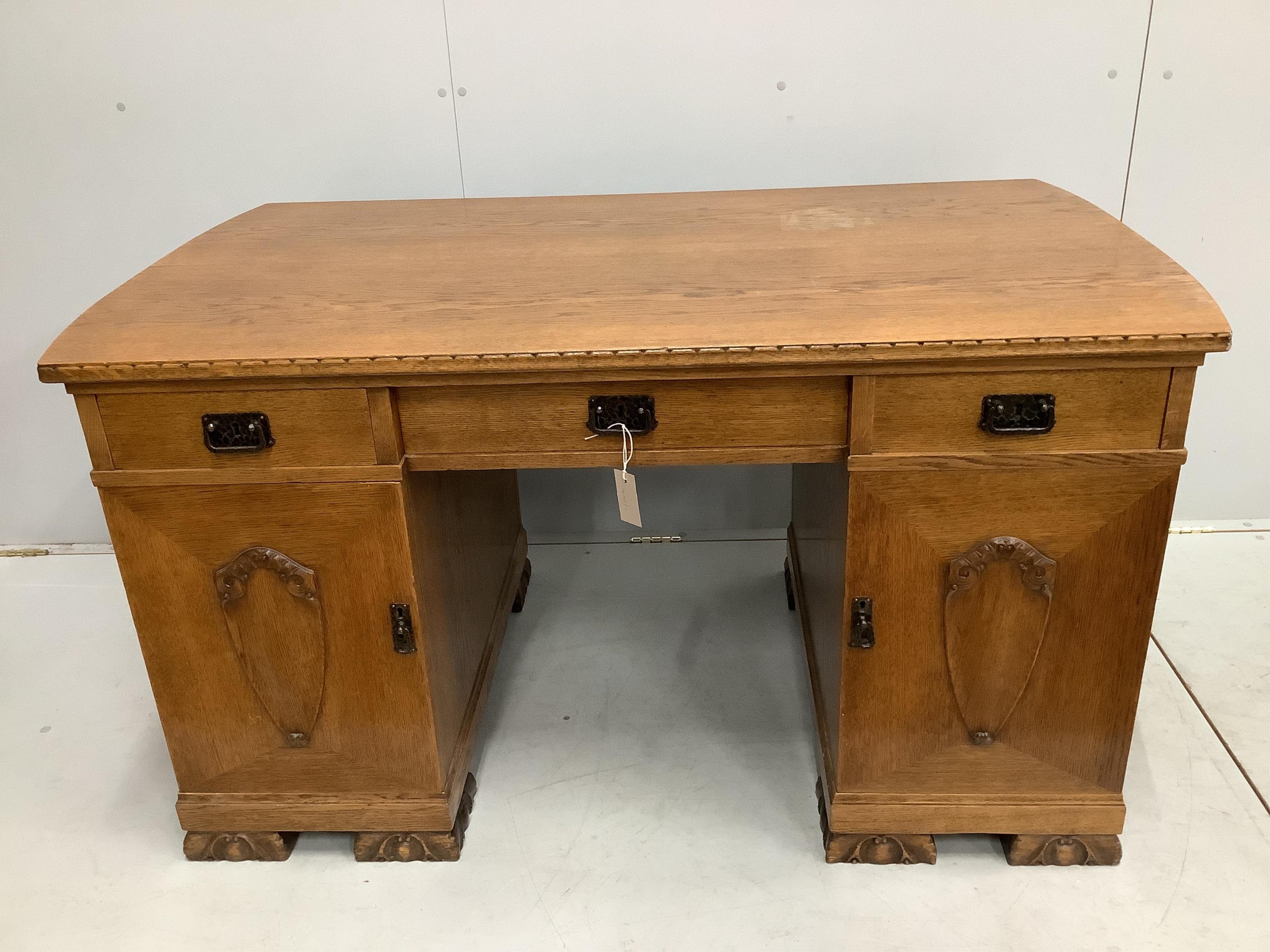 An early 20th century French oak pedestal desk, width 139cm, depth 79cm, height 76cm. Condition - fair